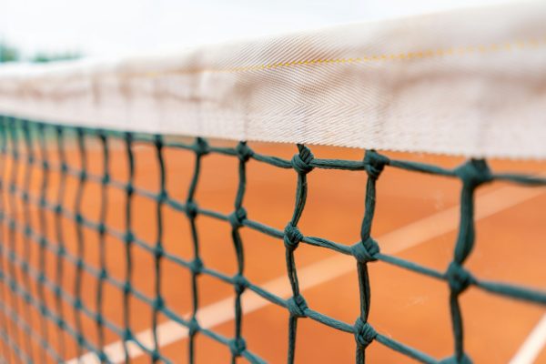 close-up of a net on an outdoor tennis court competition training sports equipment